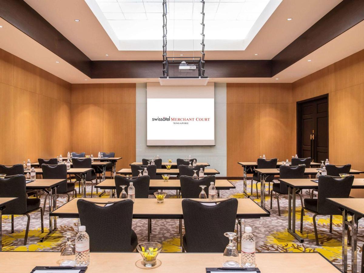 Paradox Singapore Merchant Court At Clarke Quay Экстерьер фото The image shows a conference room setup. It features rows of tables arranged with chairs, creating a professional space suitable for meetings or presentations. In the front of the room, there is a large screen set against a light-colored wall, likely