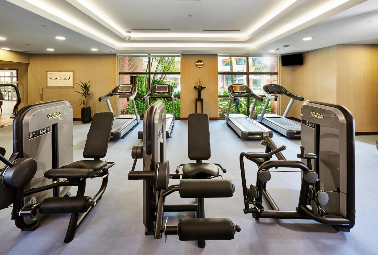 Paradox Singapore Merchant Court At Clarke Quay Экстерьер фото The photo shows a gym or fitness center with various exercise equipment. There are several treadmills positioned against large windows that let in natural light, and some strength training machines are arranged in the space. The gym has a modern desi