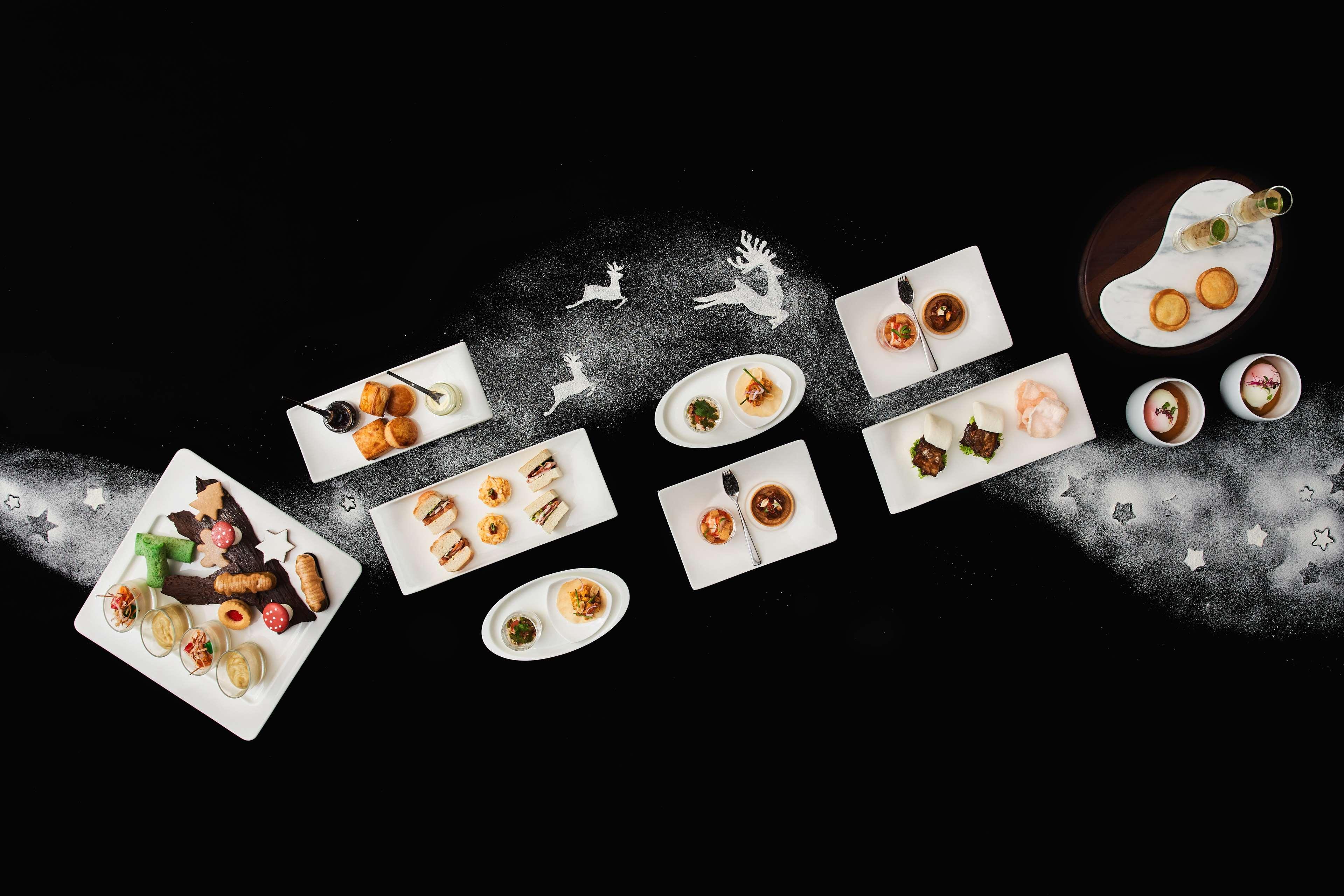 Paradox Singapore Merchant Court At Clarke Quay Экстерьер фото The photo showcases an elegant arrangement of various dishes presented on white plates, set against a dark background. The dishes include an assortment of culinary items, possibly desserts and appetizers, artistically plated and garnished. There are 