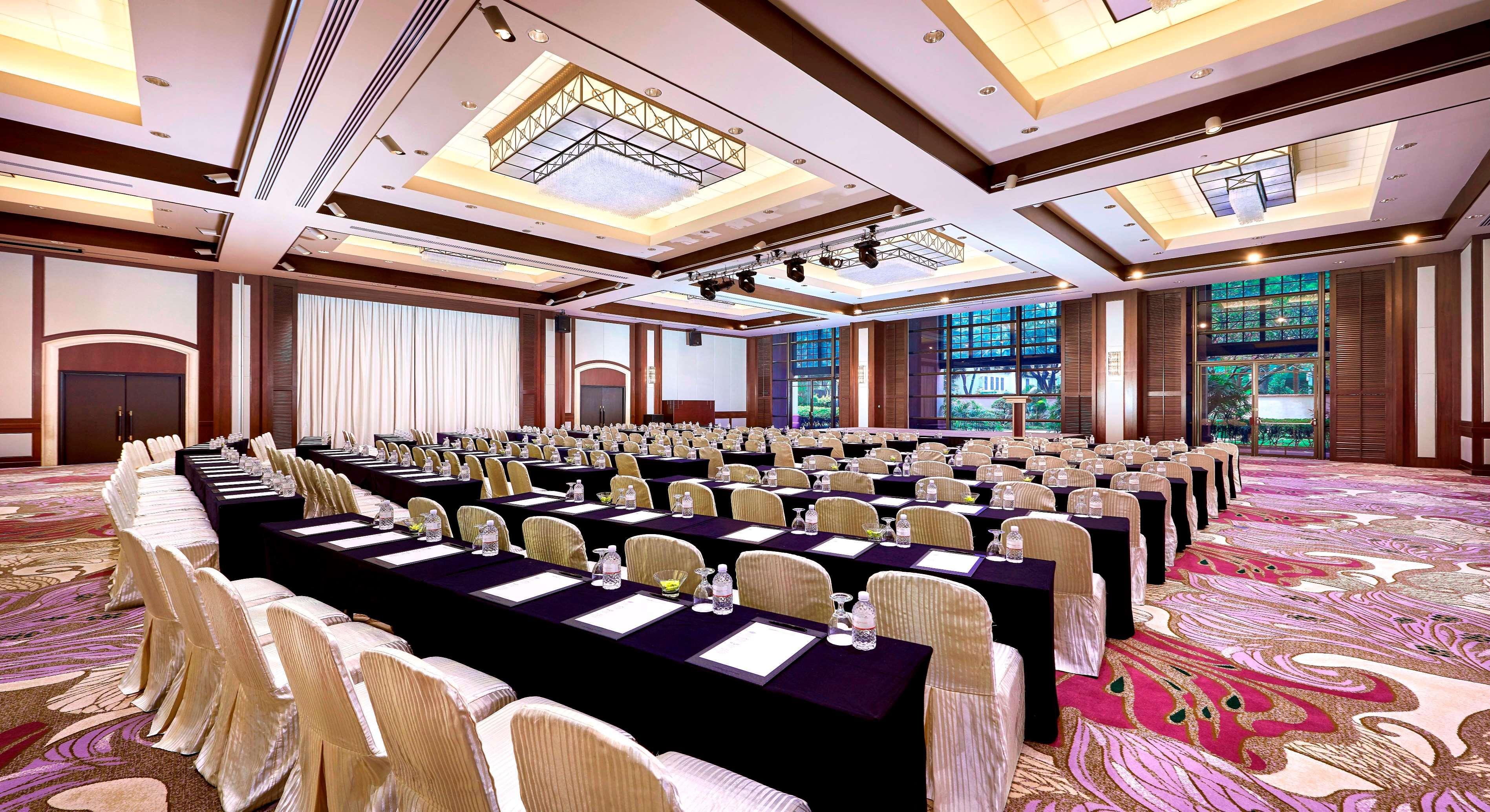Paradox Singapore Merchant Court At Clarke Quay Экстерьер фото The photo shows a large conference room set up for an event or meeting. The room features multiple rows of tables covered with black cloths and arranged with chairs. Each table has water glasses and what appears to be notepads or documents. The space